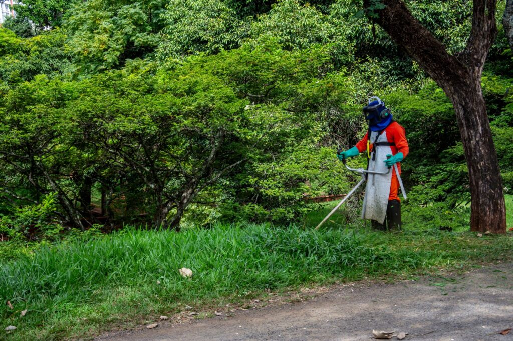 Lawn Mowing Service Near Me: Find Ocala's Trusted Pros 3 lawn mowing near me technician edging a driveway in Ocala Florida