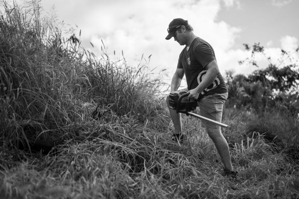 Need a Handyman for Yard Work Near Me? Ocala's 2026 Guide 1 handyman for yard work near me clearing overgrown brush in Ocala backyard
